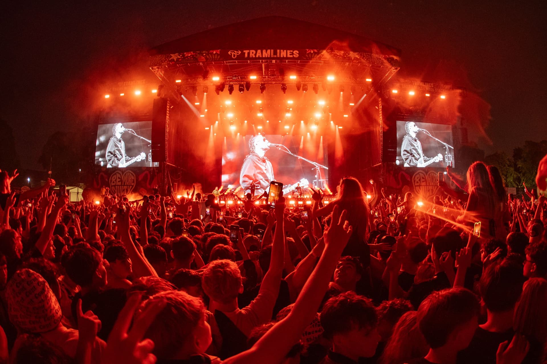 Crowd enjoying vibrant evening concert with bright stage lights