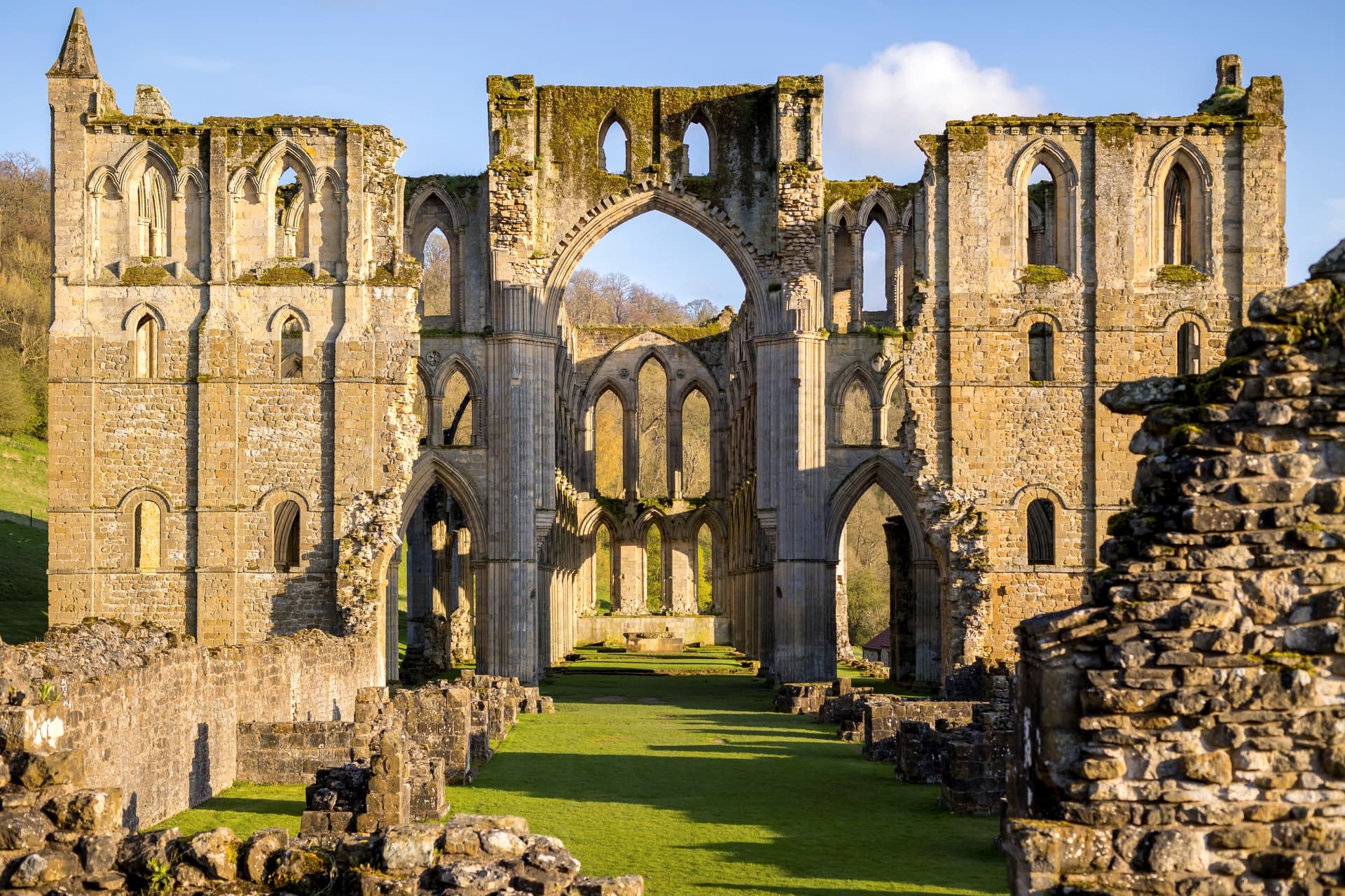 Ruins of Rievaulx Abbey with arches and moss-covered stones