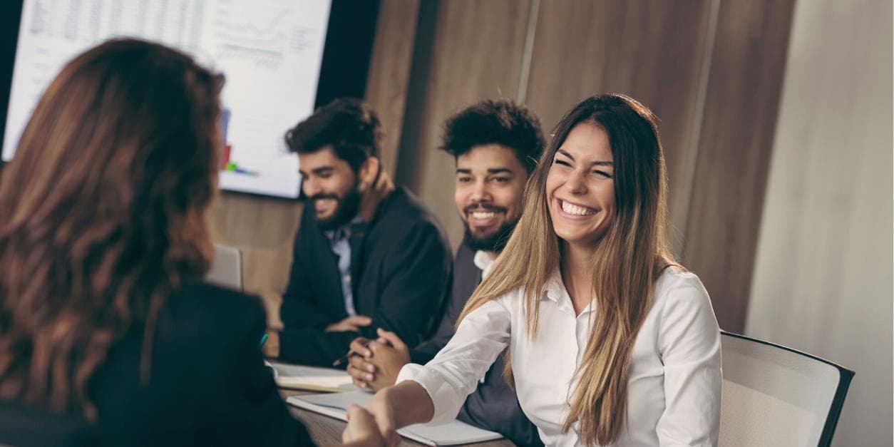 Group of professionals smiling during a business meeting