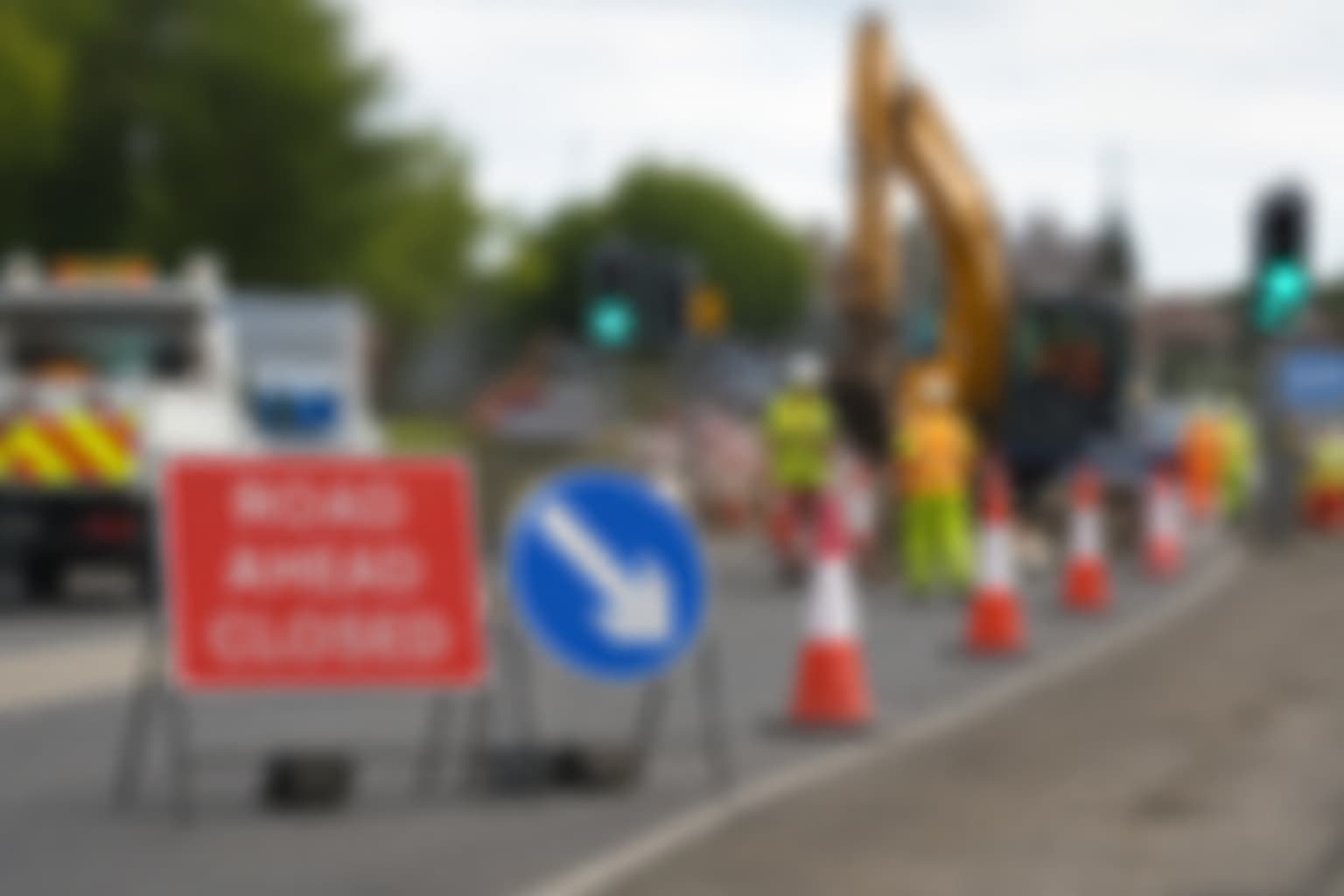 Roadworks with construction signs and digger on a Yorkshire street