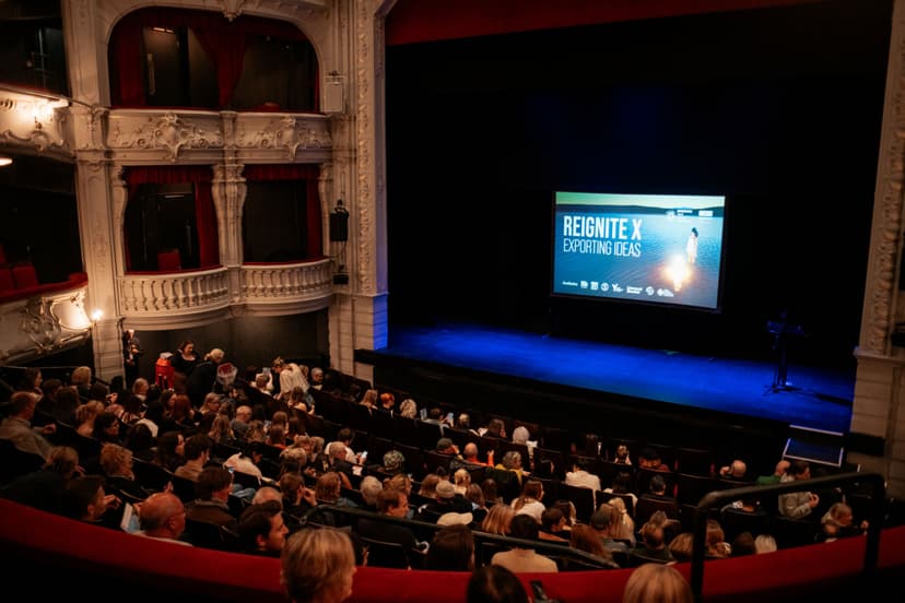 Historic theatre interior with ornate balconies and audience