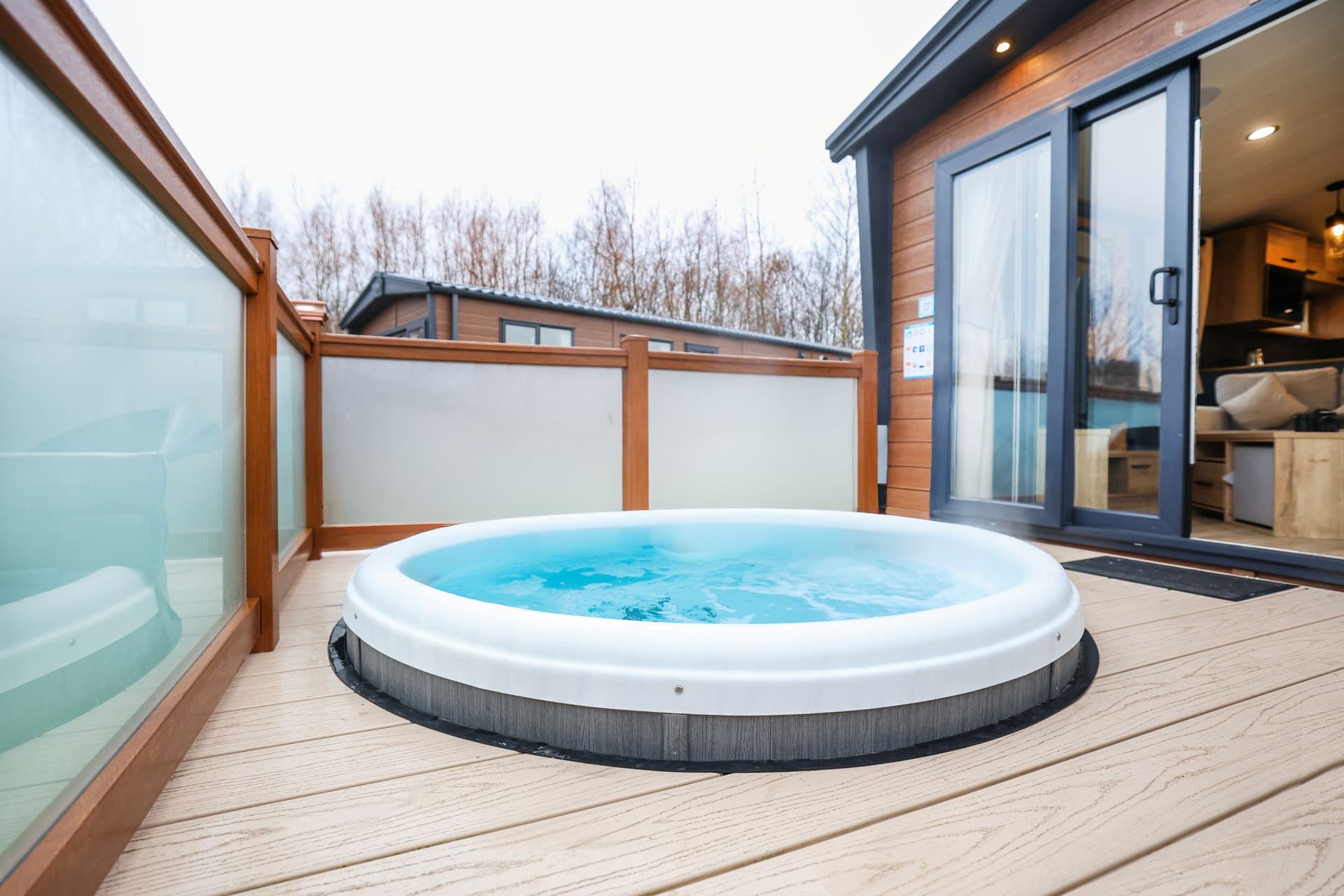 Modern wooden lodge with private hot tub on deck