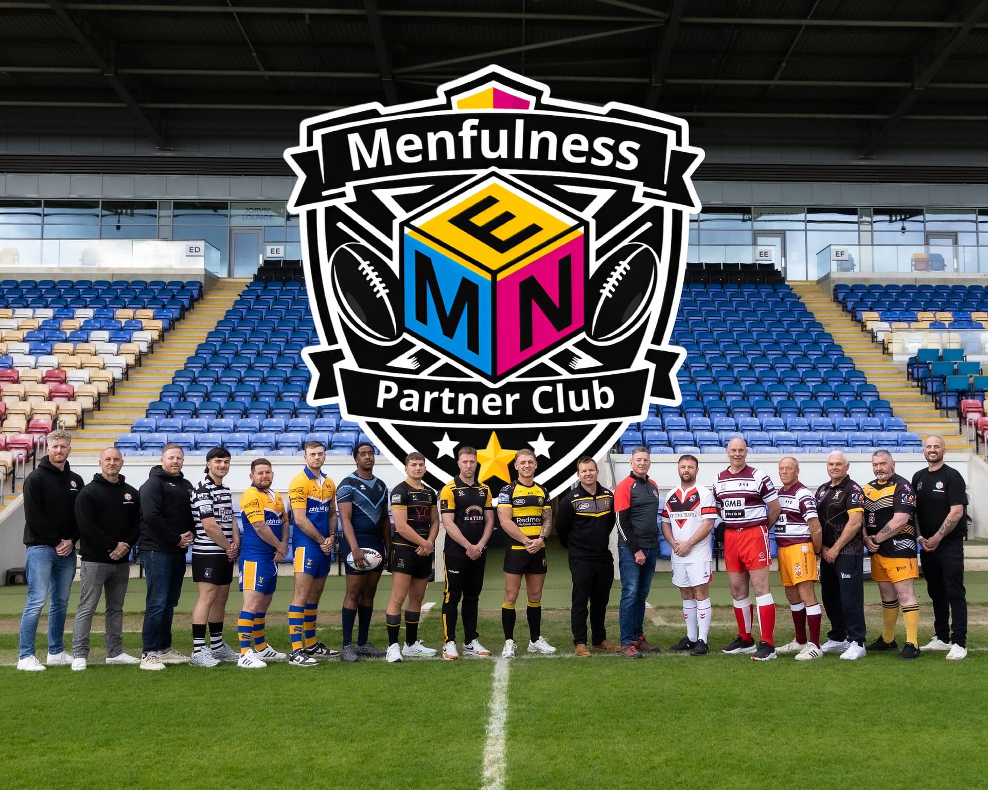 Rugby players and officials in colorful uniforms on stadium field