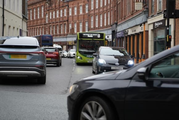 Busy city street in Yorkshire with red brick buildings