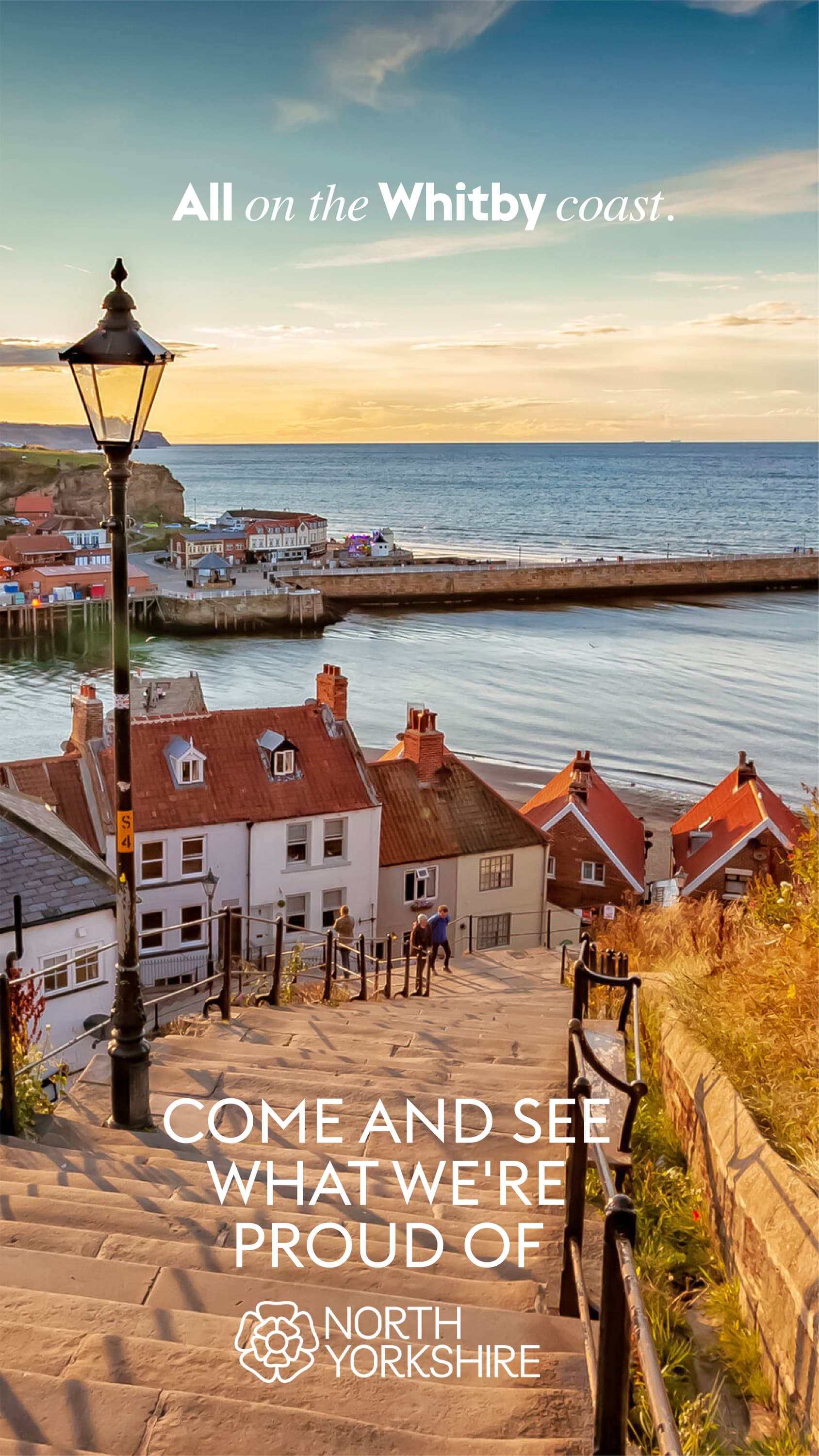 Sunset view over Whitby harbor with red-roofed cottages