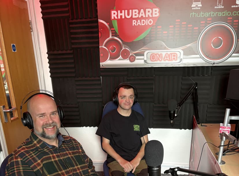 Two men in radio studio with headphones and microphones