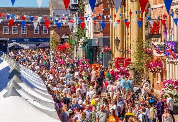 Bustling street fair with colorful bunting and crowds in Yorkshire