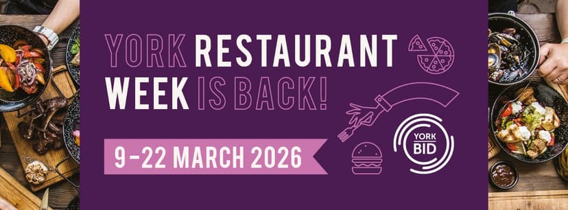 Colorful dishes with diverse cuisines arranged on rustic wooden tables, promoting York Restaurant Week in a vibrant atmosphere.