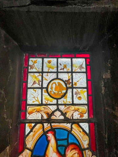 Colourful stained glass window with floral and bird designs