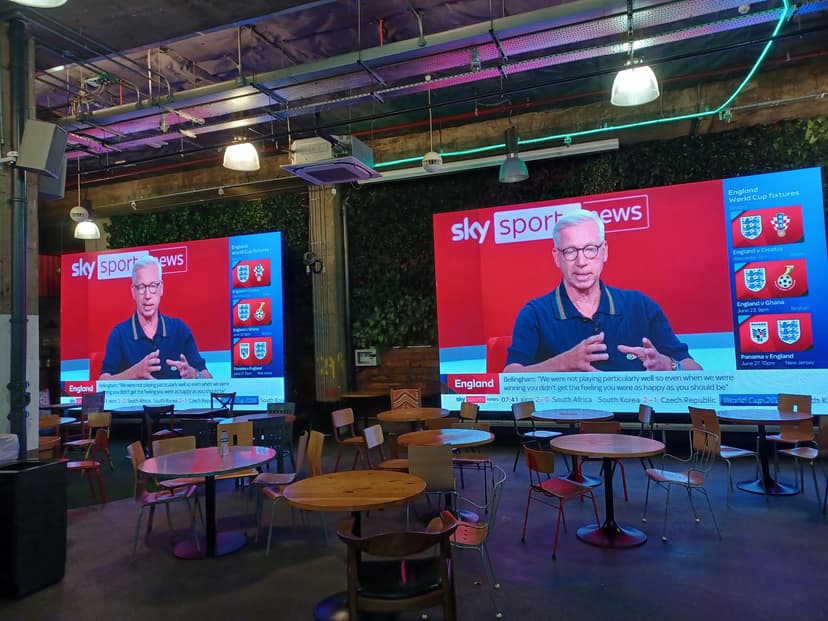 Large screen in a cafe showing a sports news broadcast