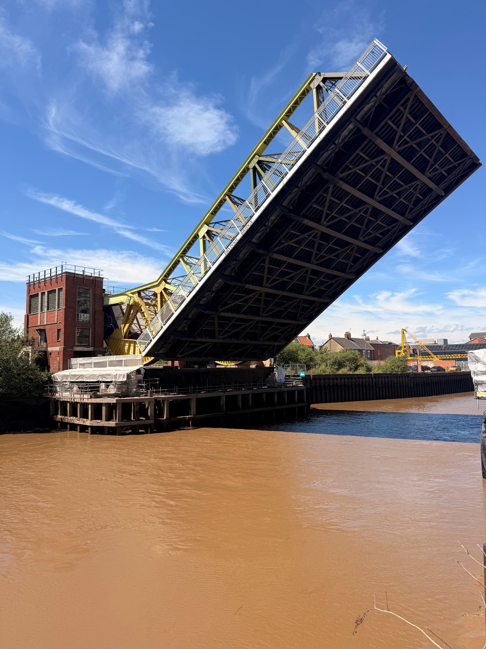 Raised drawbridge over River Hull with blue sky