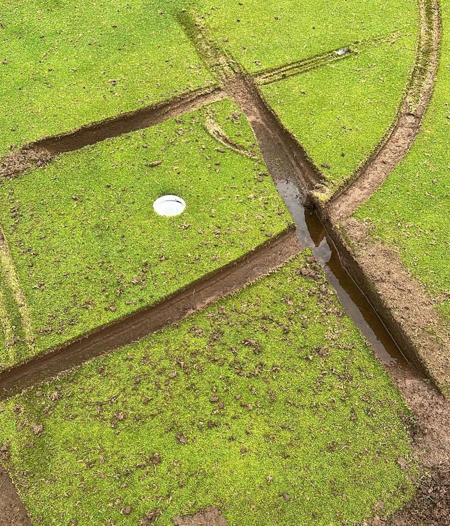 Close-up of a mini-golf course with bright green turf