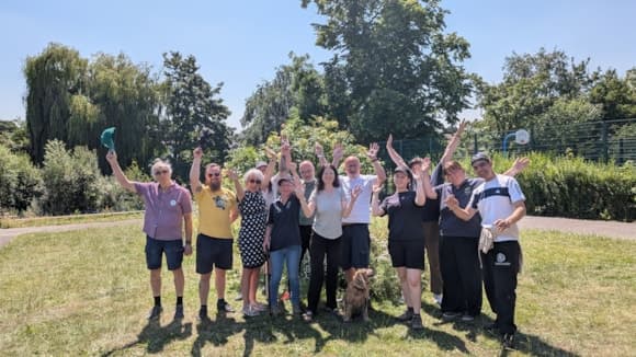 Group of people celebrating outdoors on a sunny day