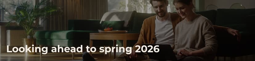 Couple sitting together on floor looking at tablet in cozy living room