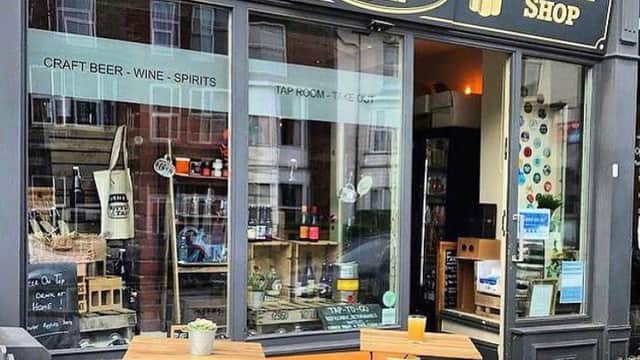 Turner's Craft Beer Bottle Shop features a stylish storefront with wooden benches, showcasing craft beer and spirits.