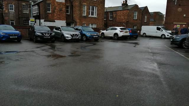 Somerset Terrace Car Park in Scarborough, featuring parked cars and brick buildings under a cloudy sky.