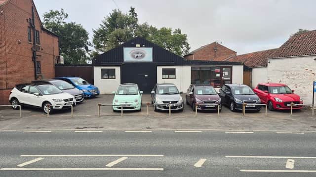 Brooklands Garage in Wetwang, Yorkshire, featuring a row of parked cars outside a brick building.