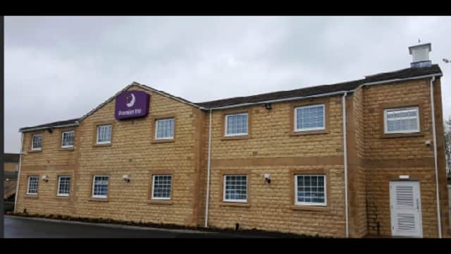 Premier Inn building with a stone facade and multiple windows, set against a cloudy sky in Gargrave, Yorkshire.