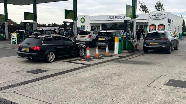 BP gas station with M&S Food shop, cars at pumps, and a cloudy sky in South Milford, Yorkshire.