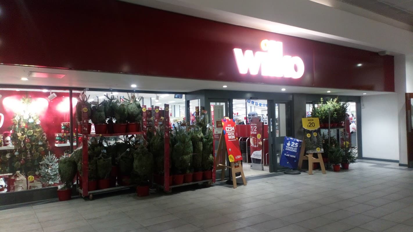 Balmoral Centre entrance featuring Wilko store, decorated with plants and Christmas displays.
