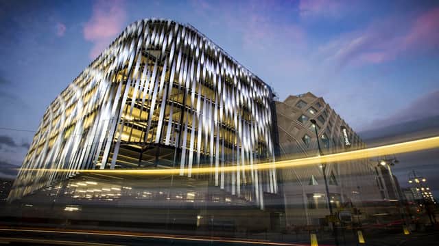 Modern multi-storey car park with illuminated facade, set against a twilight sky in Leeds, Yorkshire.