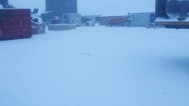Snow-covered site with containers and structures, creating a wintry scene at Marshalls Civils & Drainage in Pollington.