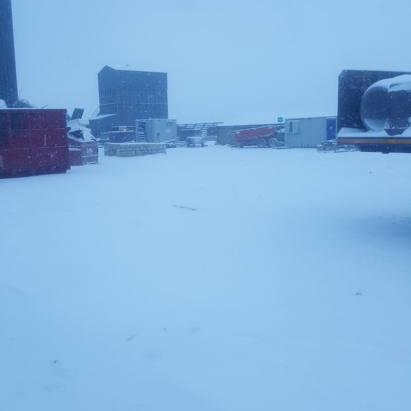 Snow-covered site with containers and structures, creating a wintry scene at Marshalls Civils & Drainage in Pollington.
