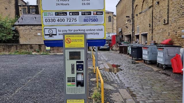 Pay & Display parking machine at Back Queen St Car Park, Huddersfield, with pricing details and contact information.