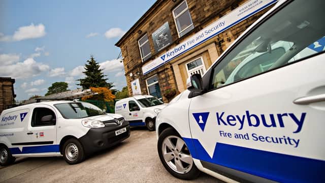 Keybury Security Systems vehicles parked outside a stone building with visible signage in Harrogate, Yorkshire.