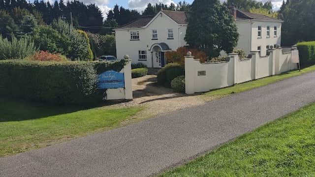 White house with a welcoming entrance, surrounded by greenery and a well-maintained garden in North Frodingham.