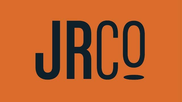 Bold black "JRCo" logo on an orange background, featuring a stylized letter "o" with a circular design.