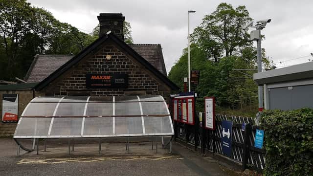 Pay & Display car park at Baildon Station with a stone building, ticket machine, and surrounding greenery.