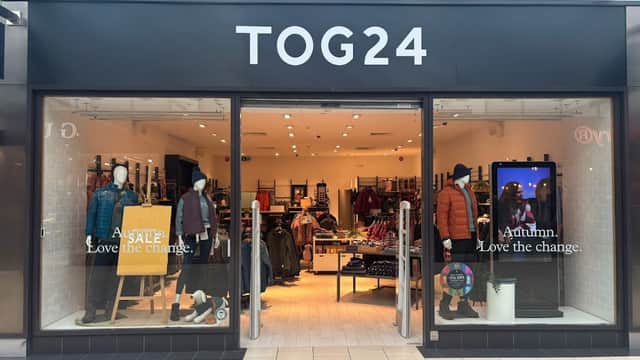TOG24 store entrance featuring clothing displays, sale sign, and autumn-themed decor in York, Yorkshire.
