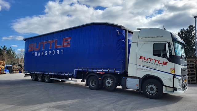 Suttle Transport truck parked at a Pay & Display area in Tockwith, Yorkshire, with a clear blue sky above.