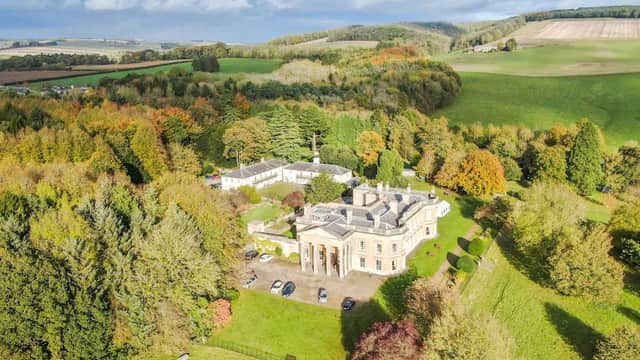 Aerial view of Madhyamaka Kadampa Meditation Centre surrounded by lush greenery and rolling hills in Yorkshire.