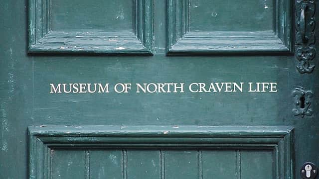 Green door with the text "MUSEUM OF NORTH CRAVEN LIFE" prominently displayed in white lettering.