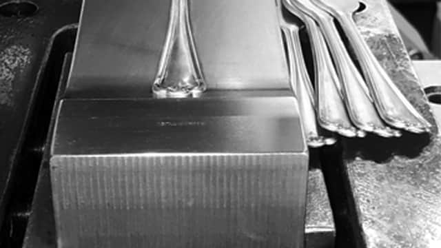 Welcome to Inkerman Silver, showcasing Sheffield cutlery manufacturing with forks placed on a metal block.