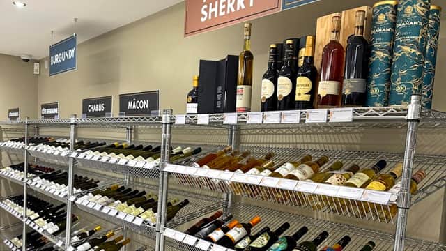 Wine shelves displaying various bottles labeled "Port & Sherry," "Sweetie Corner," "Burgundy," "Chablis," and "MΓ’con."