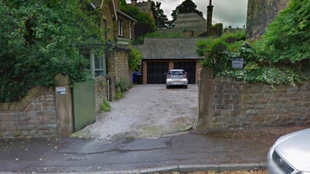 Gravel driveway leading to a garage, surrounded by stone walls and greenery in Nether Edge, Yorkshire.