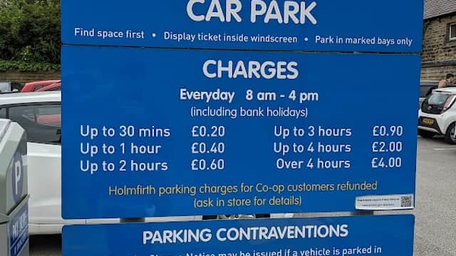 Sign for Crown Bottom Car Park with parking charges, hours, and regulations in Holme Valley, Yorkshire.