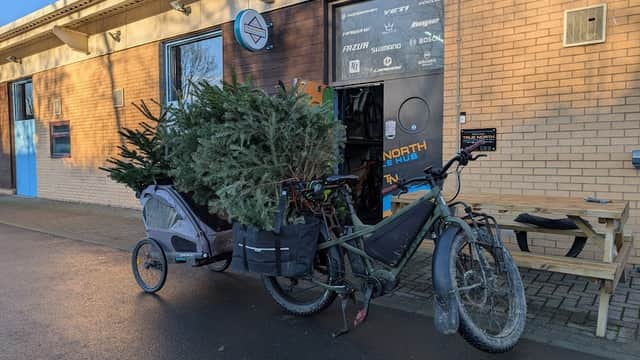 A bicycle with a trailer loaded with Christmas trees outside the Step Business Centre in Deepcar, Yorkshire.