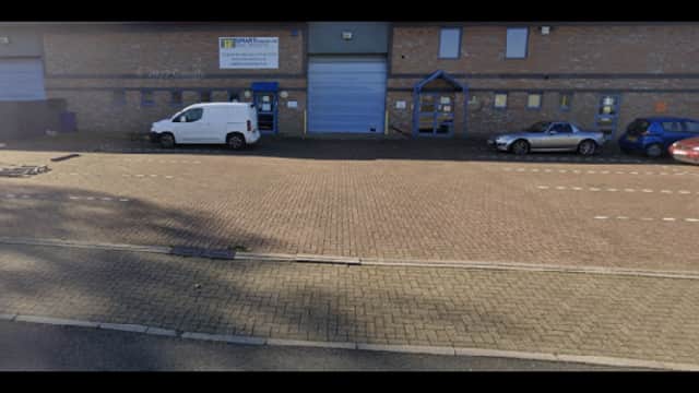 Pay & Display parking area in Attercliffe, Yorkshire, with a white van and a silver car parked alongside a brick building.