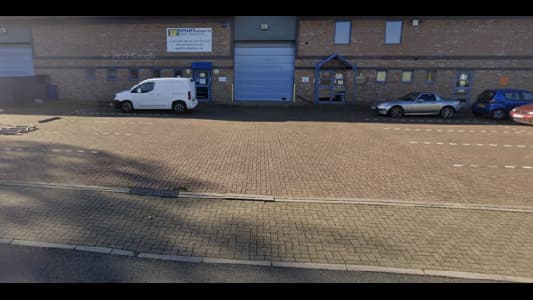 Pay & Display parking area in Attercliffe, Yorkshire, with a white van and a silver car parked alongside a brick building.