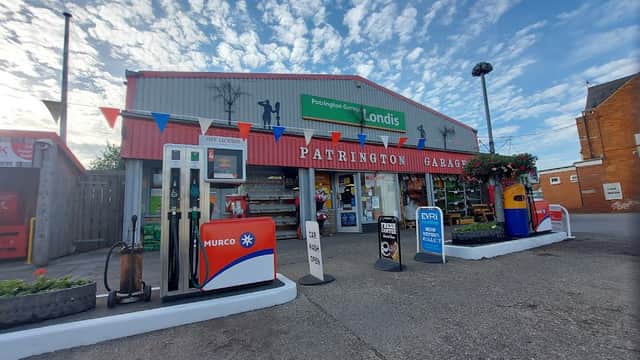 Patrington Garage with petrol pumps, a Londis sign, and colorful bunting under a blue sky.