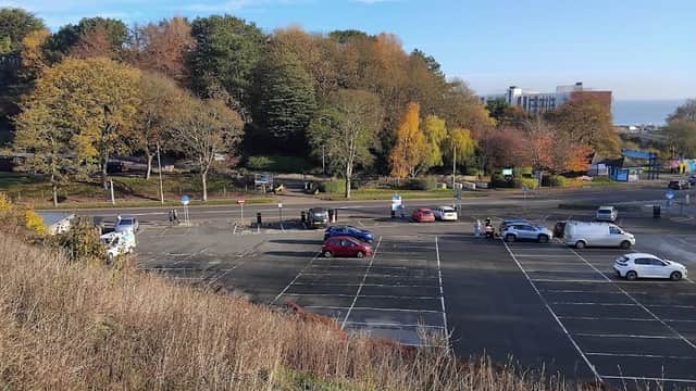 Northstead Lower Car Park in Scarborough, featuring empty parking spaces and autumn foliage under a clear blue sky.