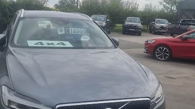 Gray Volvo SUV in foreground with price tag, surrounded by various cars at Station Garage in Flaxton, Yorkshire.