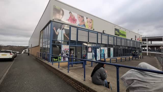 The Bazaar shopping centre in Bradford, featuring large promotional banners and a grey overcast sky.