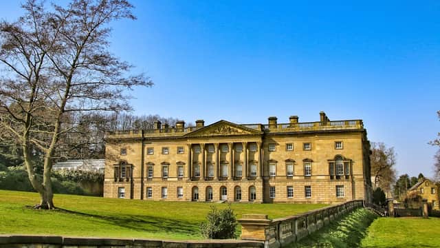 Historic Wentworth Castle Gardens with grand architecture, manicured lawns, and a clear blue sky in Hood Green, Yorkshire.
