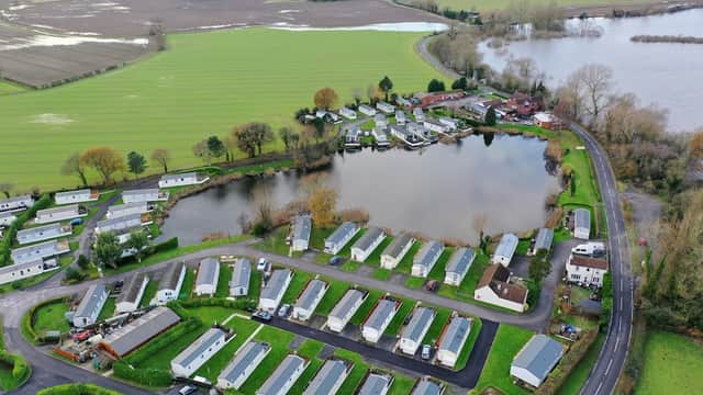Aerial view of White Cross Ski Club with mobile homes, a lake, and surrounding green fields in Cawood, Yorkshire.
