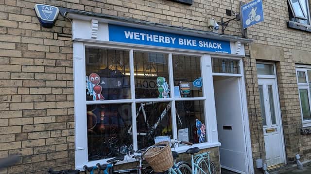 Wetherby Bike Shack storefront with colorful cartoon characters, bicycles parked outside, and a blue sign above.